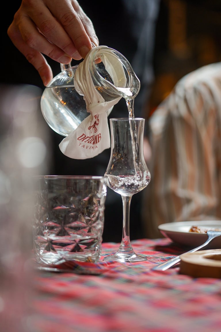 Person pouring water during dining service